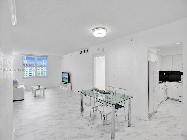 dining area featuring a textured ceiling