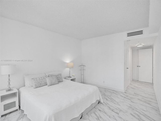 bedroom featuring a textured ceiling