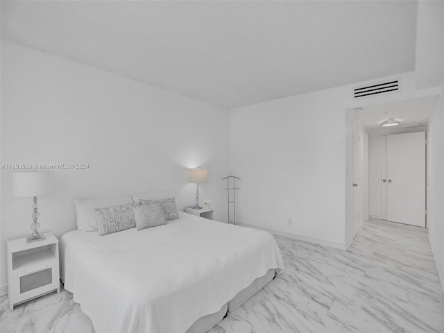 bedroom featuring a textured ceiling