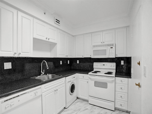 kitchen with backsplash, white appliances, sink, washer / dryer, and white cabinetry