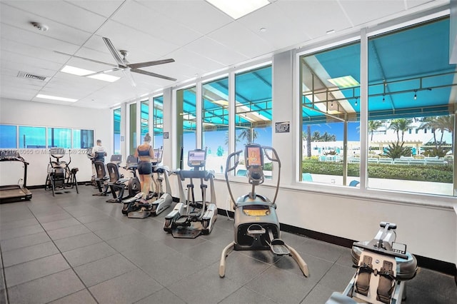 exercise room featuring a drop ceiling and ceiling fan