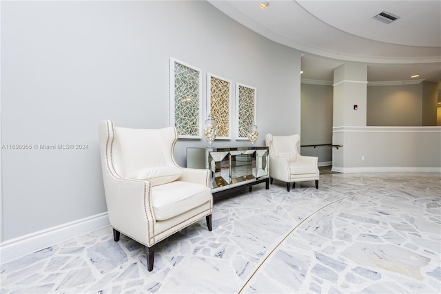 sitting room featuring crown molding