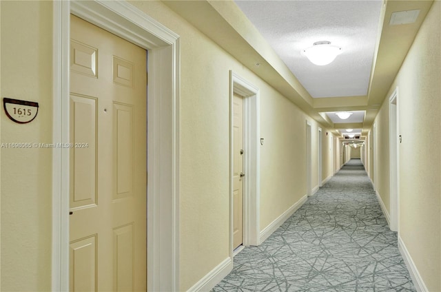 hall with a textured ceiling