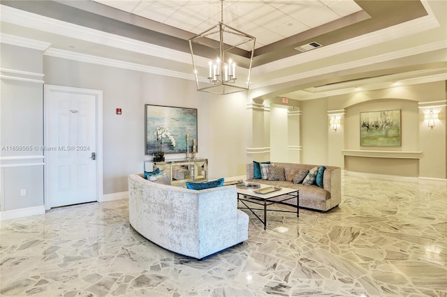 living room with a tray ceiling, an inviting chandelier, crown molding, and ornate columns