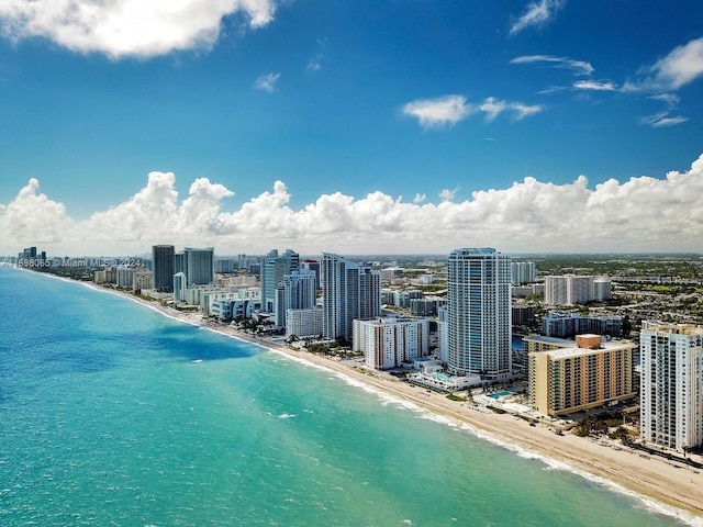 bird's eye view featuring a view of the beach and a water view