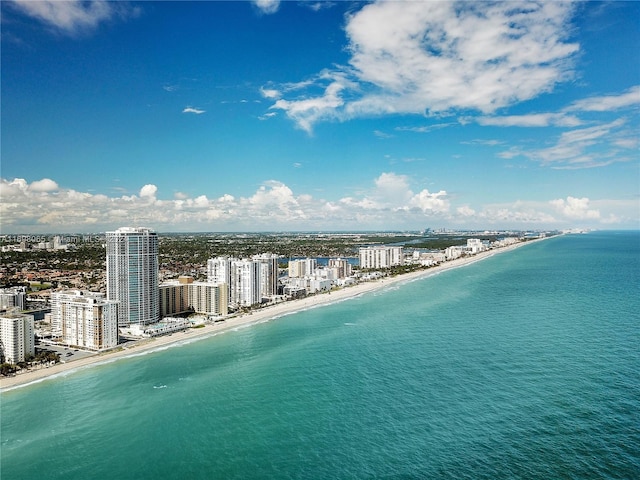 bird's eye view with a water view and a beach view