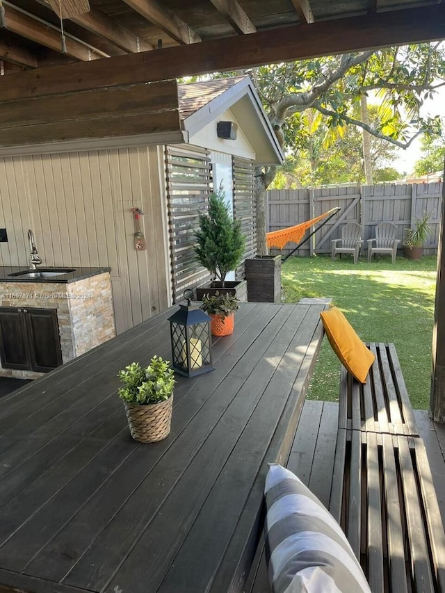 deck with a lawn and sink