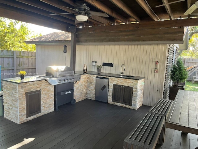 wooden deck with ceiling fan, sink, and an outdoor kitchen