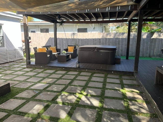 view of patio / terrace featuring an outdoor living space, ceiling fan, a deck, and a hot tub