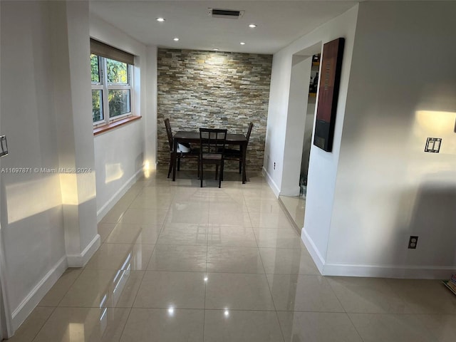 hall featuring light tile patterned flooring