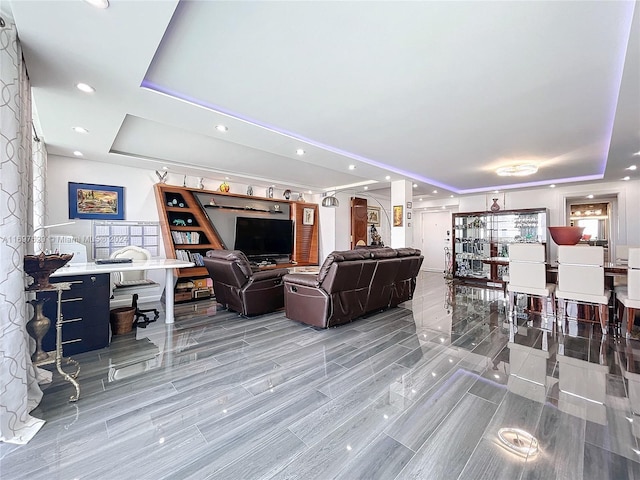 living room featuring a raised ceiling