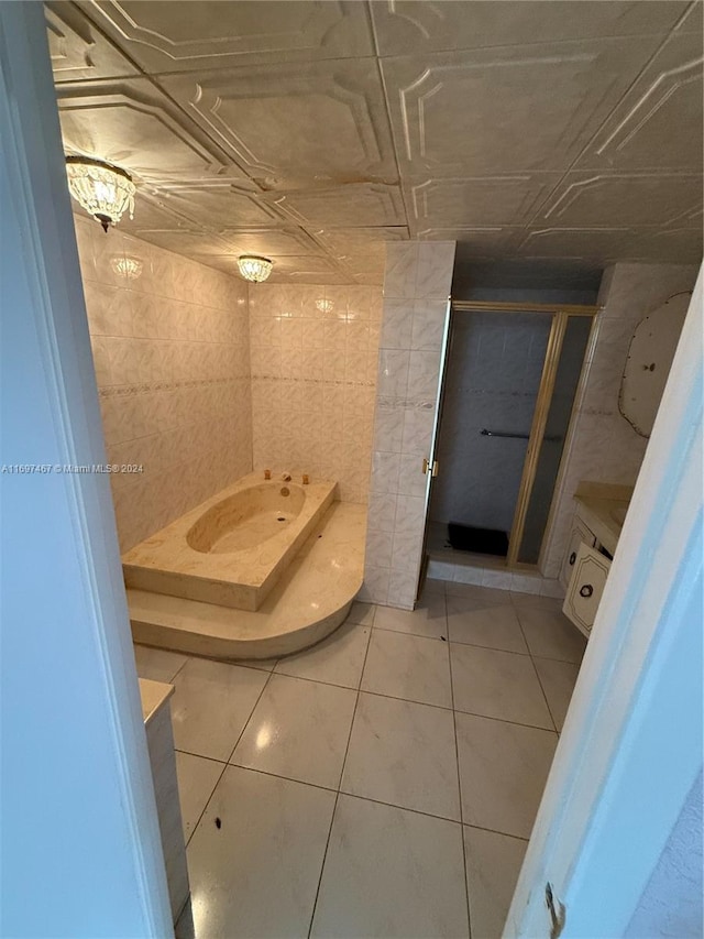 bathroom with tile patterned flooring, a shower, and tile walls