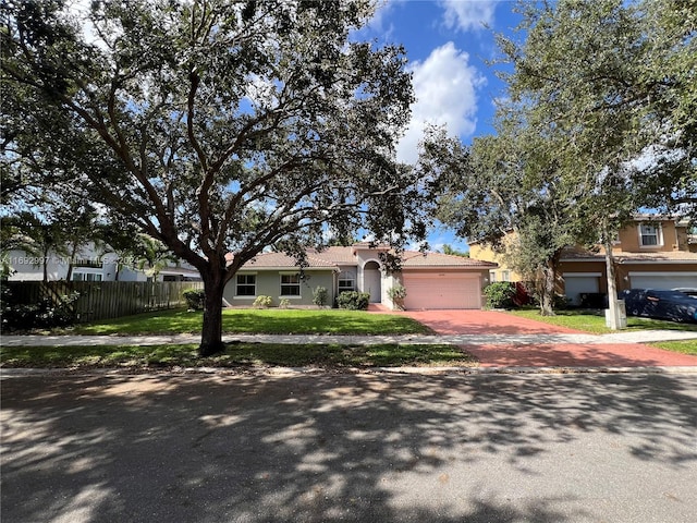 ranch-style home with a front yard and a garage