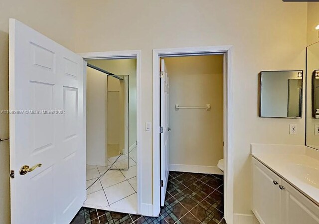 bathroom with tile patterned floors, vanity, and toilet