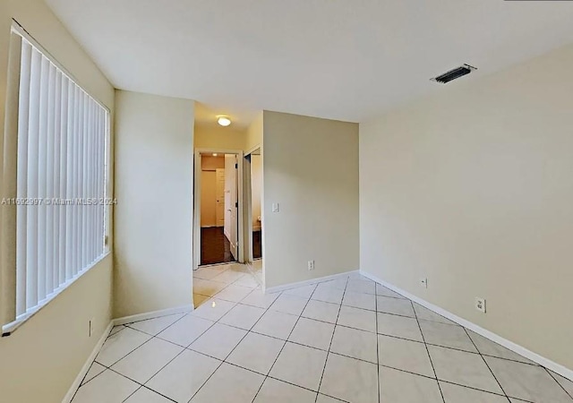 empty room with light tile patterned floors