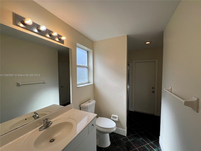 bathroom featuring tile patterned floors, vanity, and toilet