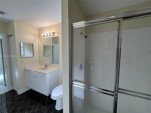 bathroom featuring a shower with door, vanity, and toilet