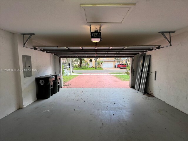 garage featuring a garage door opener and electric panel