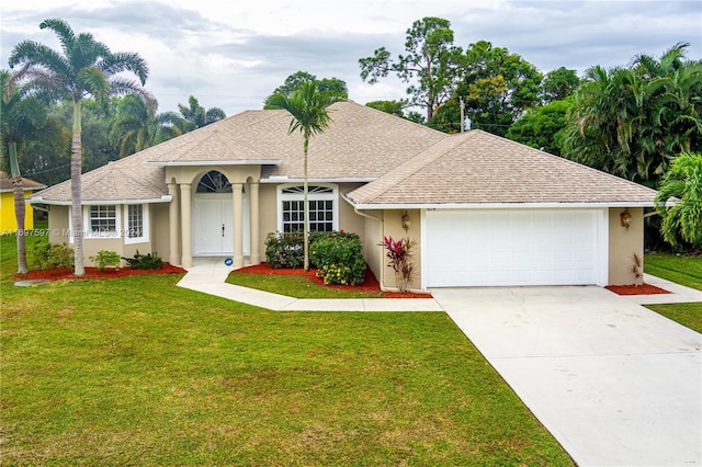 single story home featuring a front lawn and a garage