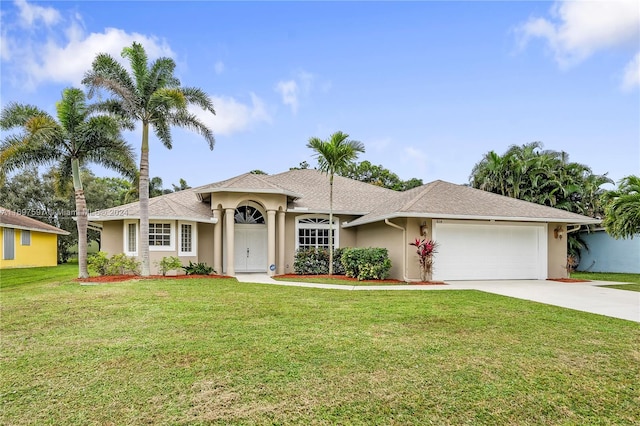 ranch-style home with a garage and a front yard