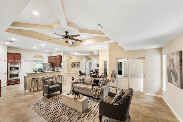 living room with ceiling fan with notable chandelier and light tile patterned flooring