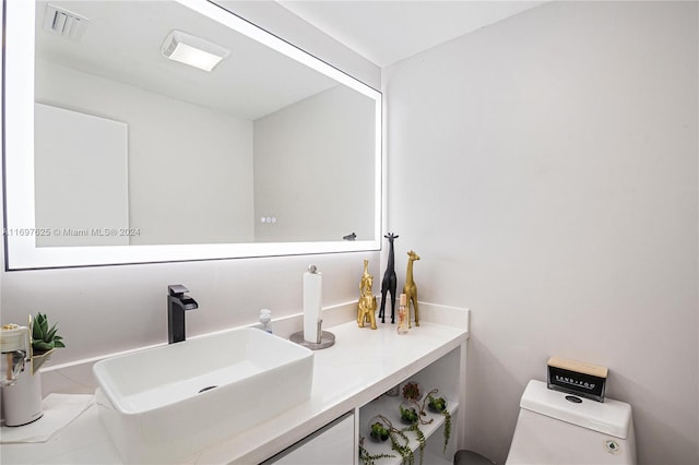 bathroom with vanity and toilet