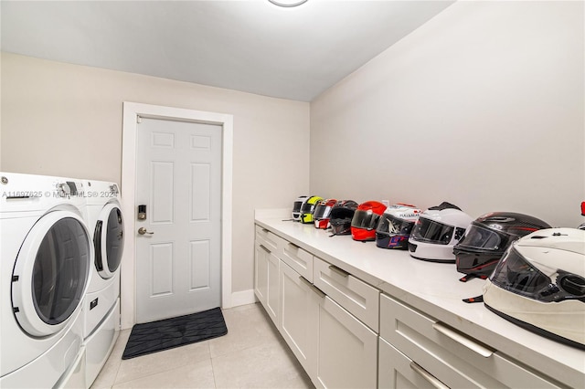 laundry room with cabinets, washing machine and dryer, and light tile patterned floors