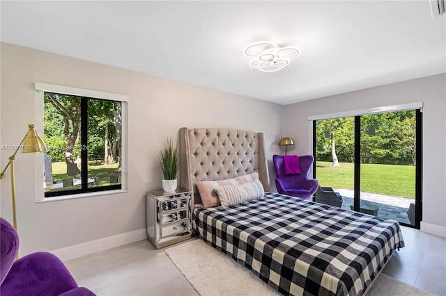 bedroom featuring access to exterior and multiple windows