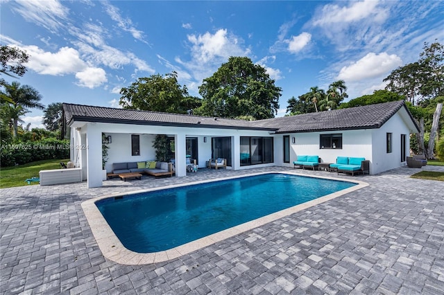 view of pool with outdoor lounge area and a patio