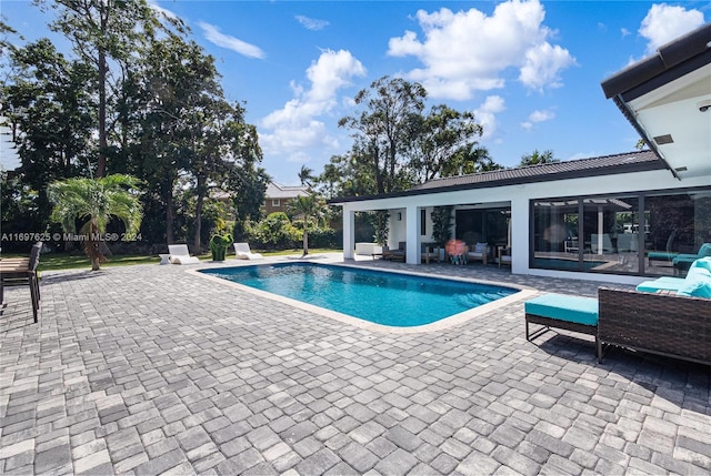 view of swimming pool featuring a patio area