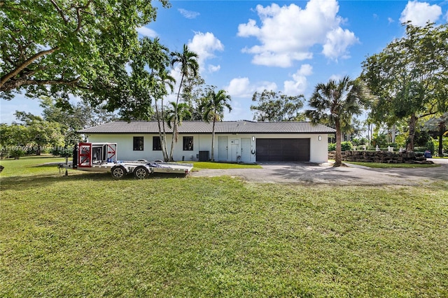 ranch-style house featuring a front yard and a garage