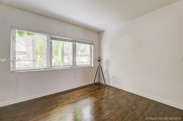 spare room with dark hardwood / wood-style floors