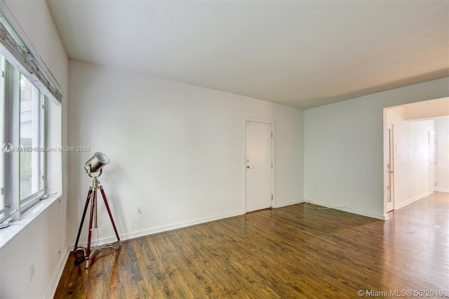 spare room with dark wood-type flooring