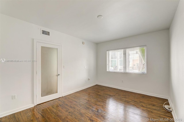 spare room with dark hardwood / wood-style flooring