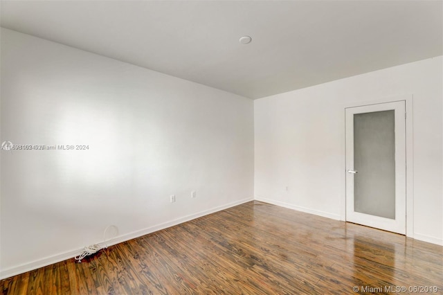 unfurnished room with wood-type flooring