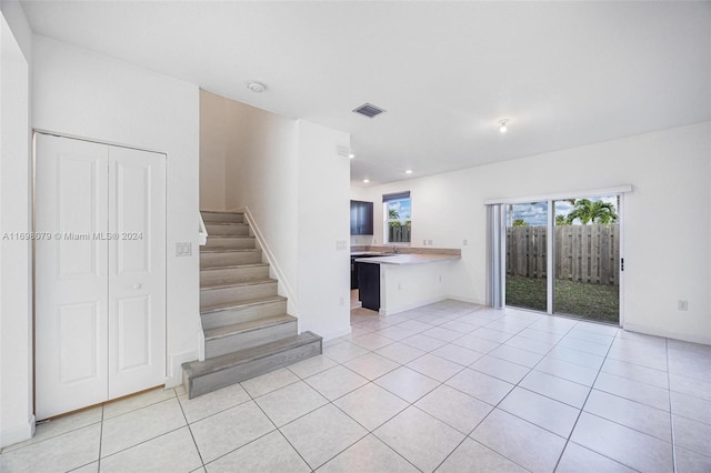 unfurnished living room featuring light tile patterned flooring