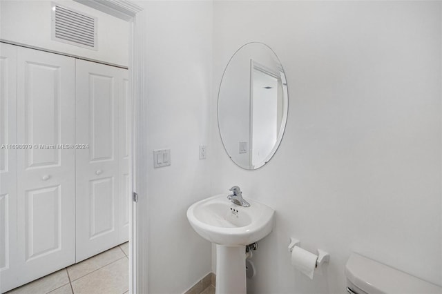 bathroom featuring tile patterned flooring and toilet