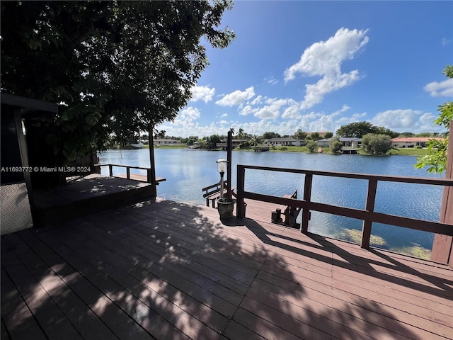 view of dock with a deck with water view