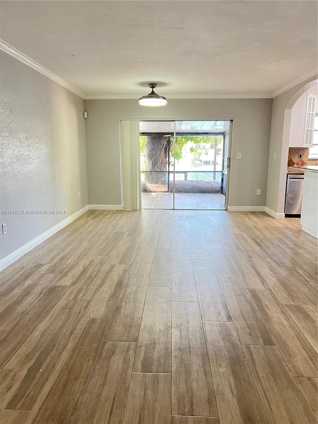 unfurnished living room with light hardwood / wood-style floors and crown molding