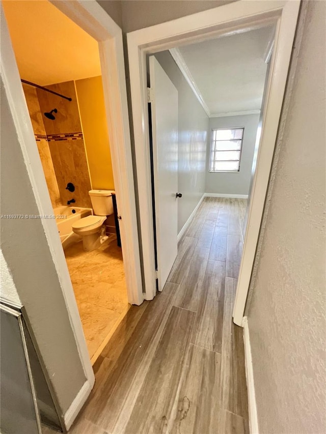 hall featuring hardwood / wood-style floors and crown molding