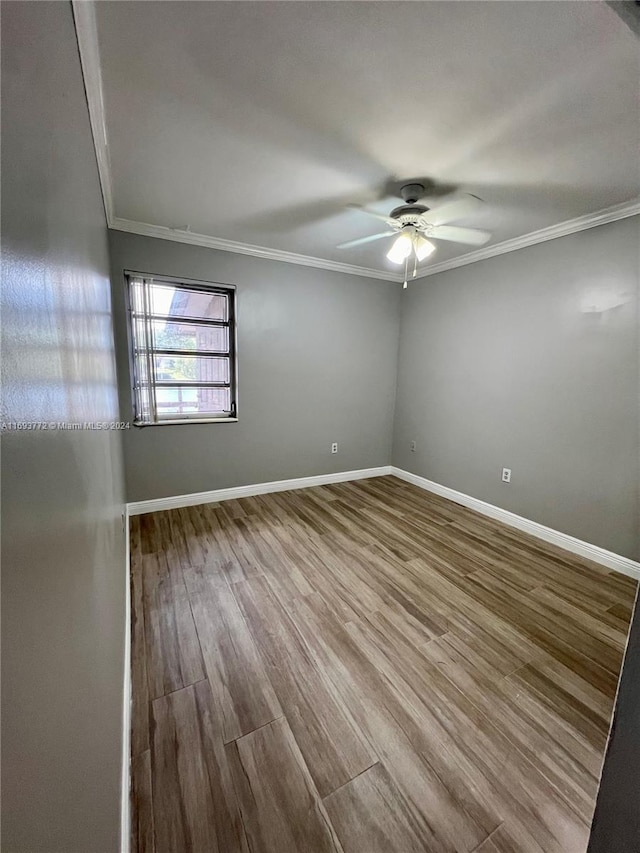 empty room with hardwood / wood-style floors, ceiling fan, and crown molding