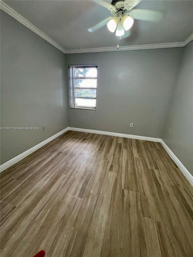 spare room with ceiling fan, wood-type flooring, and crown molding