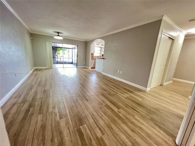 unfurnished room featuring light hardwood / wood-style floors and crown molding