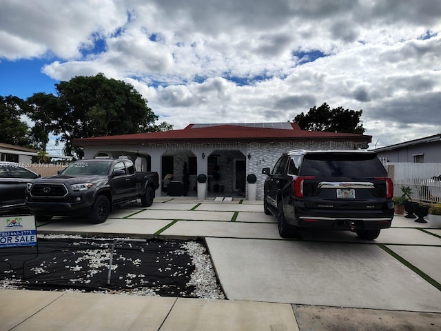 view of front of house featuring solar panels