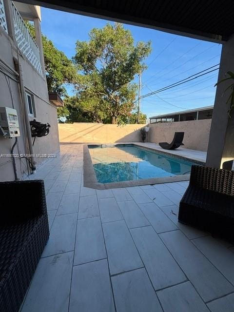 view of swimming pool with a patio area