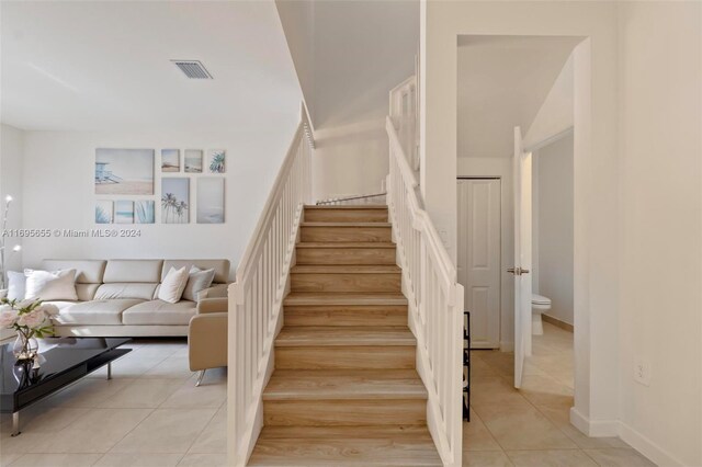 stairway featuring tile patterned flooring