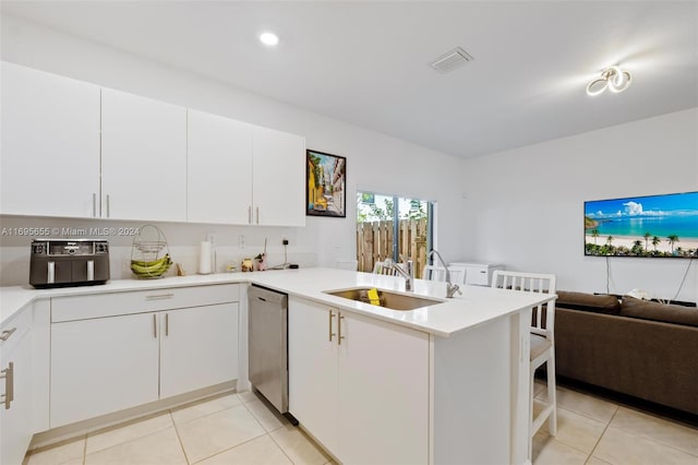 kitchen with dishwasher, white cabinetry, kitchen peninsula, and sink