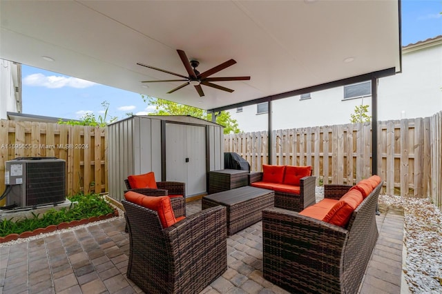 view of patio featuring central AC unit, an outdoor living space, ceiling fan, and a storage unit