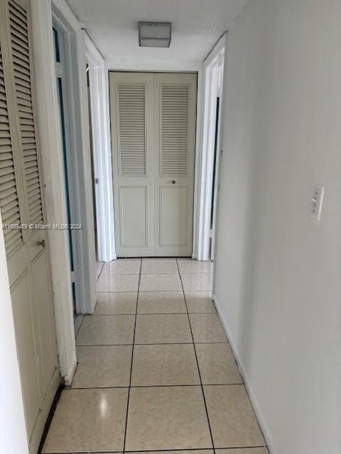 hallway with light tile patterned floors