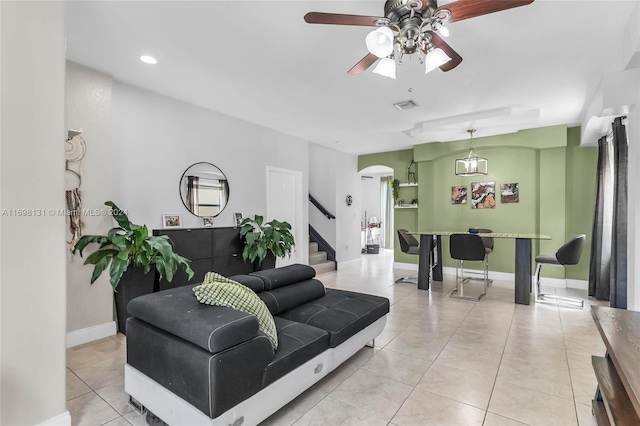 living room featuring light tile patterned floors and ceiling fan